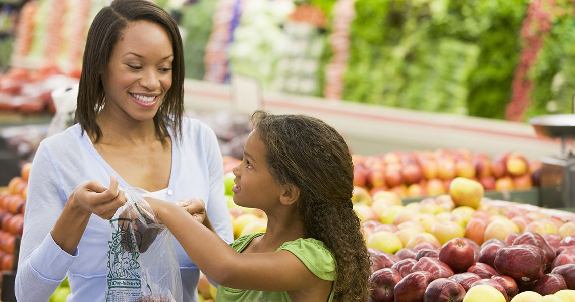 Mother and daughter shopping for produce