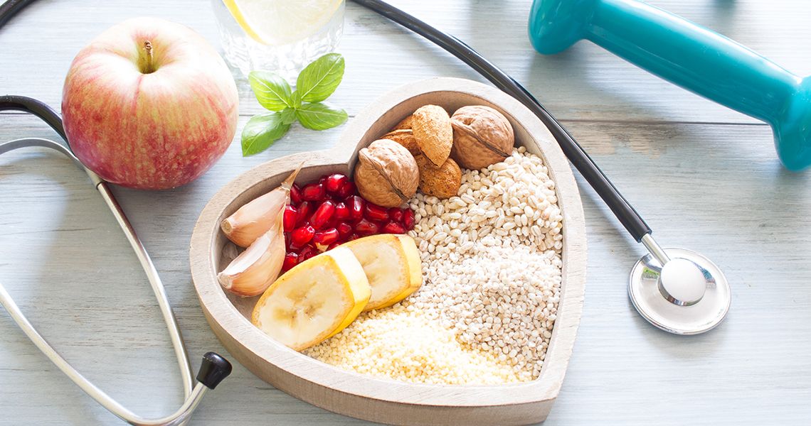 Bowl of seeds and fruit, stethoscope, and a dumbell
