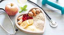 Bowl of seeds and fruit, stethoscope, and a dumbell