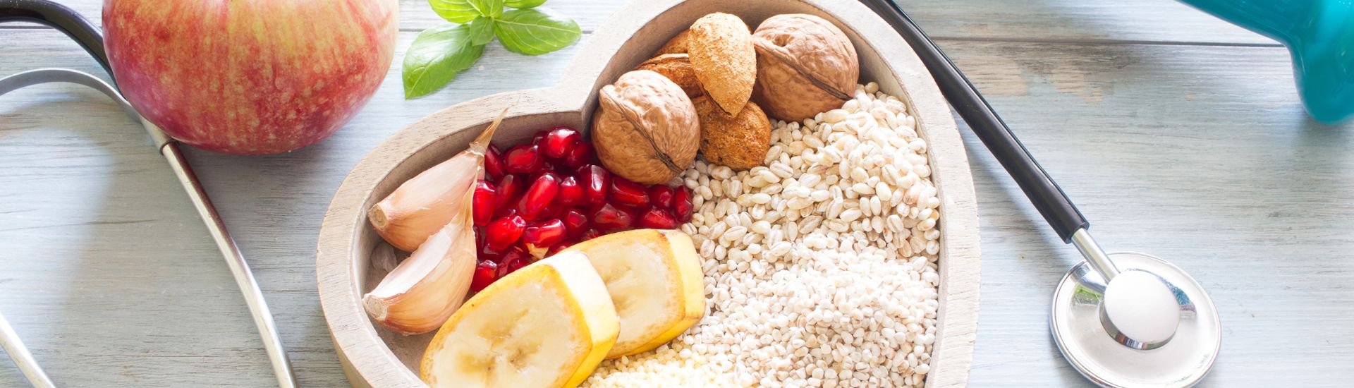 Bowl of seeds and fruit, stethoscope, and a dumbell